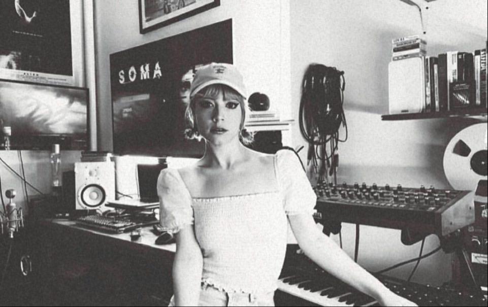 NYC synth musician DanZ CM of Computer Magic posing with her analog synthesizers
