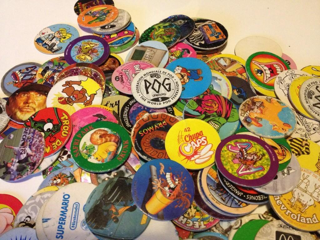 Stacks of colorful 1990s POGs milk caps and metal slammers from the retro collecting craze