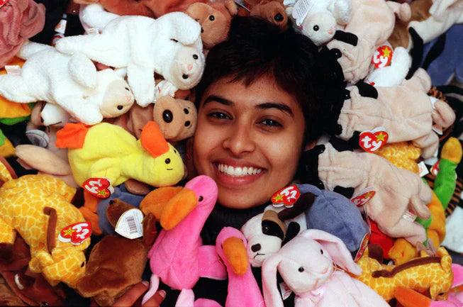 A collection of vintage 1990s Ty Beanie Babies plush animals with their iconic heart-shaped swing tags