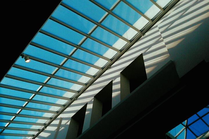 Abandoned dead mall interior with neon and palms evoking vaporwave nostalgia