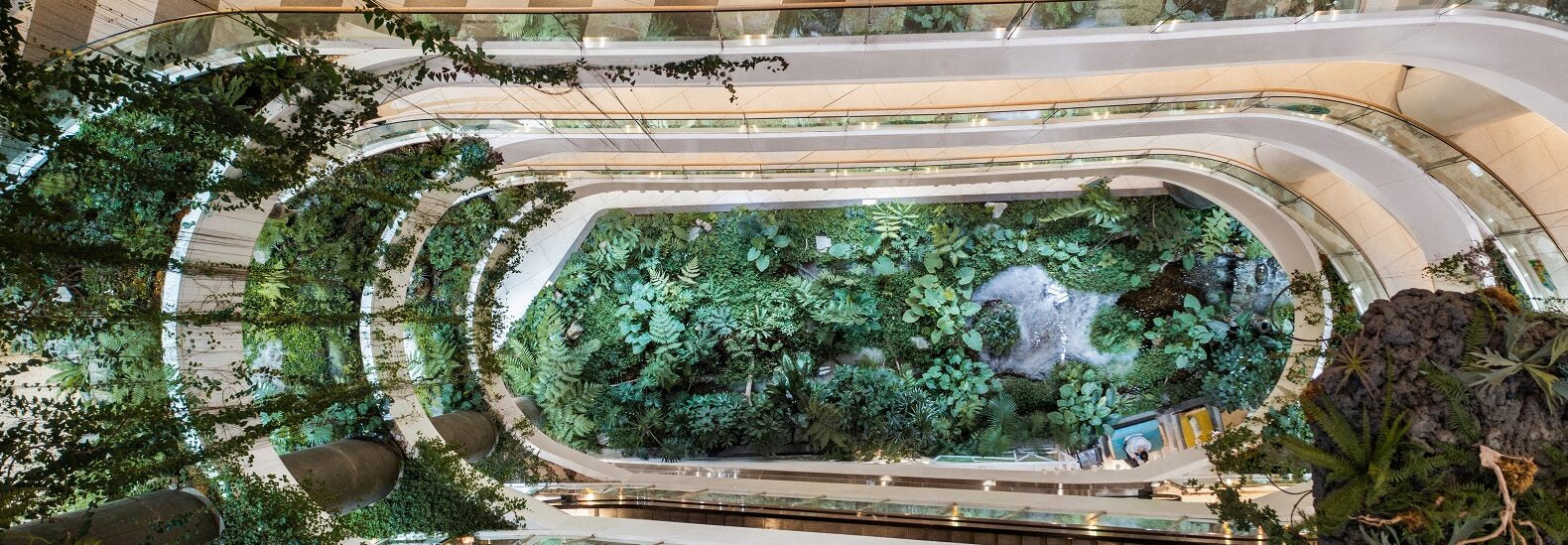 An abandoned American shopping mall interior, ripe for repurposing into affordable housing or community space