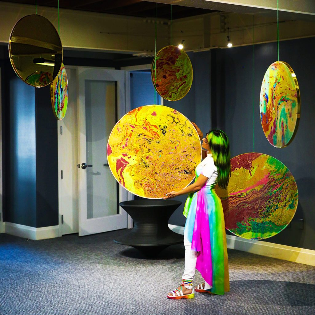Haiiileen ORBIIIT installation: hydro-dipped acrylic panels in circular gold mirror frames