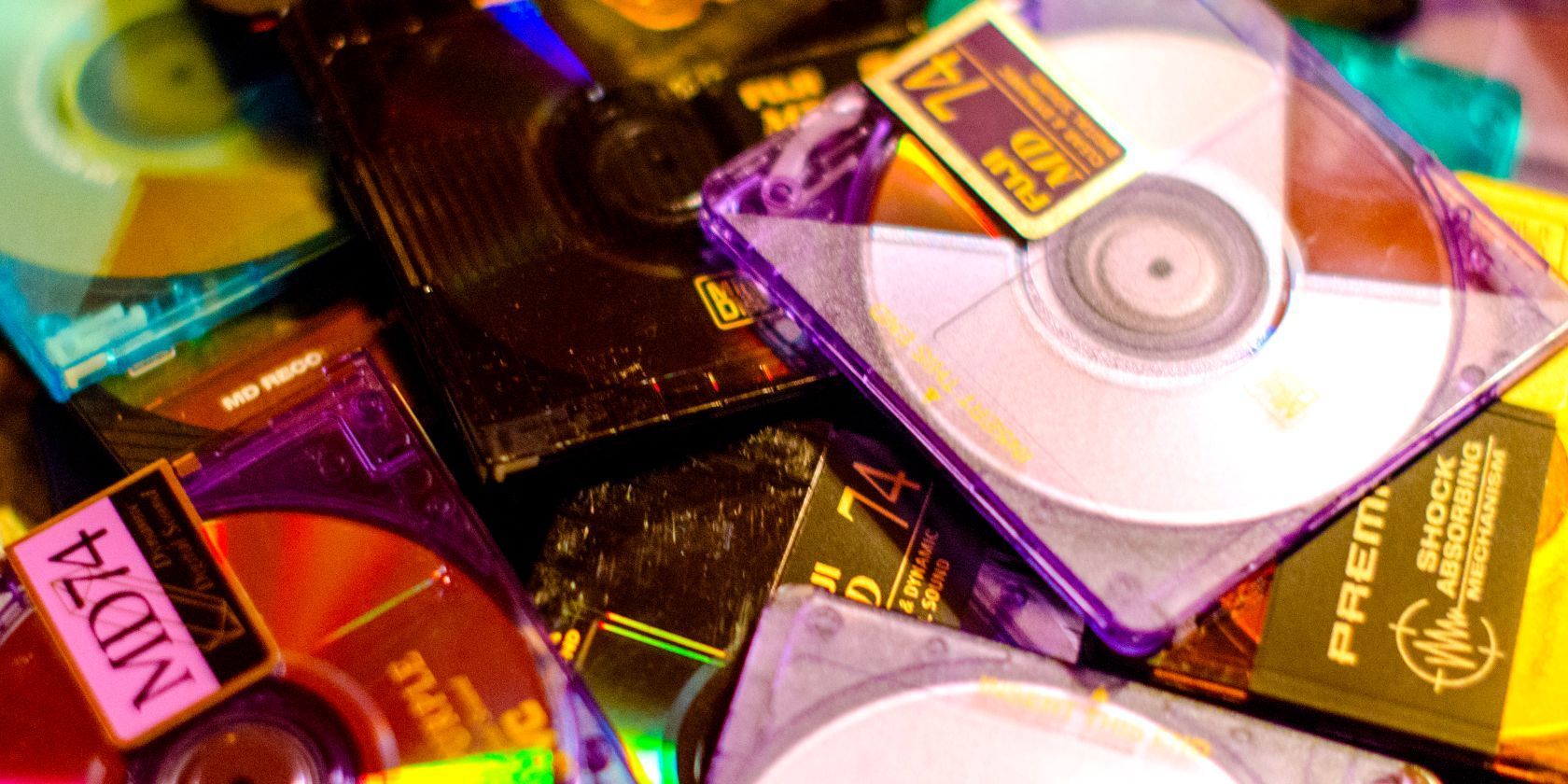 Retro Sony MiniDisc player with colorful MiniDiscs, a nostalgic 90s portable music format